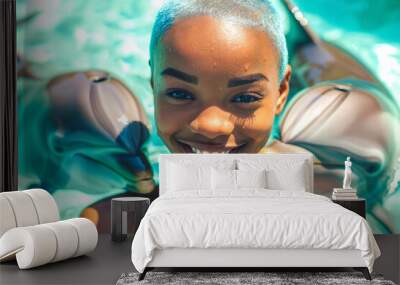 Close-up of a beautiful young African American woman with a radiant smile, submerged in the clear turquoise water of a swimming pool with two graceful dolphins by her side. Watersports. Wall mural