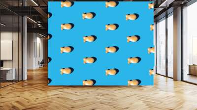 goldfish snack pattern on a blue background with a sharp light. minimal flat lay aesthetic Wall mural