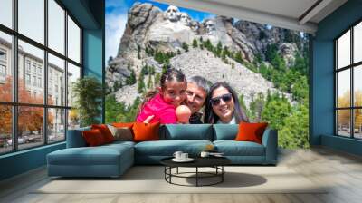 A happy family of three people visiting Mt Rushmore, South Dakota Wall mural