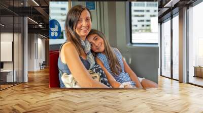 A woman and her daughter on the subway train Wall mural