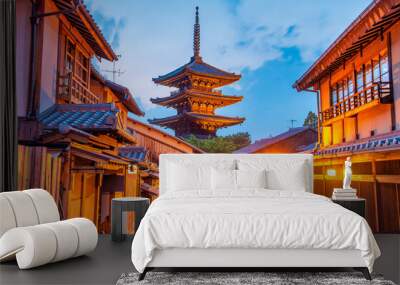 Ancient buddhist temple of Hokan-ji in old town of Kyoto in the early night. Blue glowing sky contrasts with traditional pagoda Wall mural