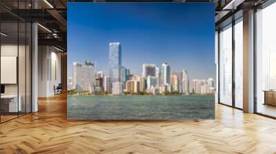 Panoramic view of Downtown Miami, Miami Beach Skyline and city port from Rickenbacker Causeway at sunset, with two airplanes in the sky Wall mural