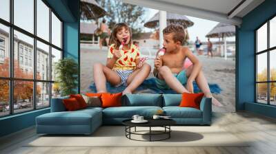 Happy kids eating ice cream on the beach Wall mural