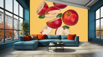 Minimal fruit concept with fresh sliced and whole apple floating in the air isolated on yellow background. Wall mural