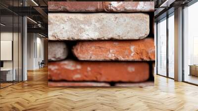 A close-up view of stacked red bricks, emphasizing the aged textures and earthy tones suitable for themes of construction, history, or durability in design. Wall mural