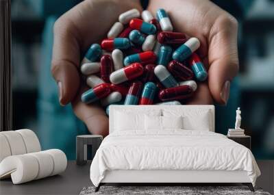 A pair of hands gently cradles a collection of colorful pills and capsules, symbolizing healthcare or pharmaceutical themes and the diversity of medications available. Wall mural