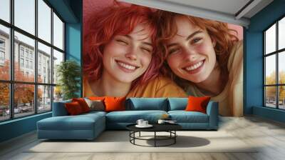 Close-up of two friends with freckles and vibrant hair, wearing casual clothes, captured against a pink wall, expressing happiness and camaraderie. Wall mural