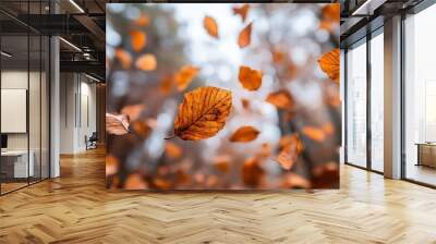 This image captures the beauty of autumn with leaves gracefully falling in a forest, creating a vibrant and dynamic visual representation of the changing seasons. Wall mural