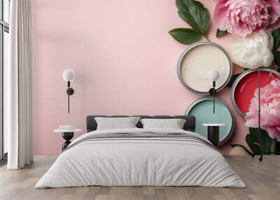 This image showcases a flat lay of various skincare products, including pink, blue, and white creams, decorated with vibrant pink peonies on a light pink background. Wall mural