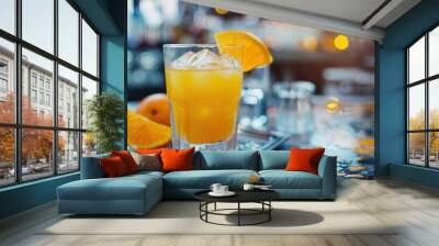 A glass of juice and fresh orange fruit closeup view on table in a restaurant bar Wall mural