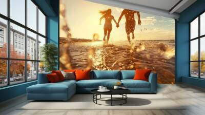 A lovely couple walking on sandy beach with sea water at sunset Wall mural