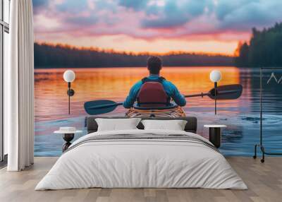 A man kayaking in water at sunset Wall mural