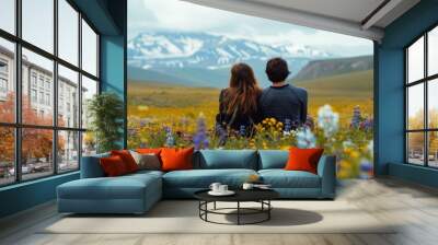 Back view of a lovely couple in wild flower field with snow mountain Wall mural