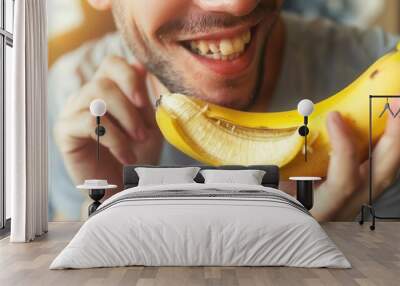 Closeup view of a person eating fresh banana fruit Wall mural