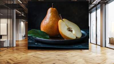 Fresh pear fruit and cut with dark background on table Wall mural