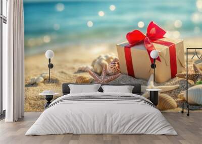 Gift box on sunny sandy beach with shells starfish for holiday closeup view Wall mural