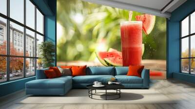 Glass of juice and fresh sweet ripe watermelon on table Wall mural