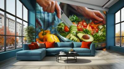 Hands making a salad dish with fresh avocado vegetable fruit closeup view Wall mural