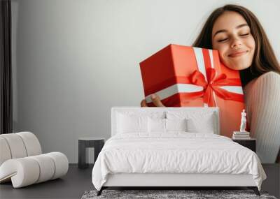 Happy female with gift box in holiday season. Wall mural