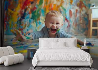 Happy little boy playing with paint Wall mural