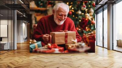 Happy senior man with gift box in holiday season. Wall mural