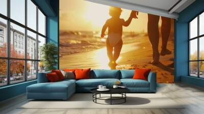 Little cute baby walk with parents outdoors with warm sunlight at beach Wall mural