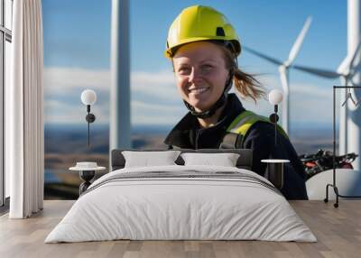 Portrait of a female field engineer in front of a wind turbine. Concept for green renewable energy. Wall mural