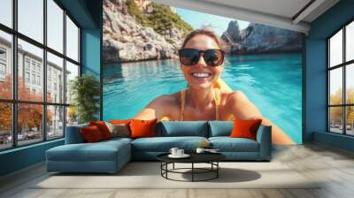 Portrait of a happy female in kayak boat exploring rocky valley in shallow sea Wall mural