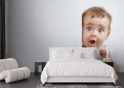 Surprised baby peeping with plain background Wall mural