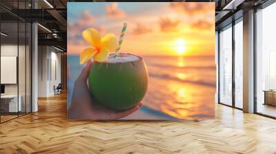 Tasty coconut drink with straw in hot tropical summer at sunset beach Wall mural