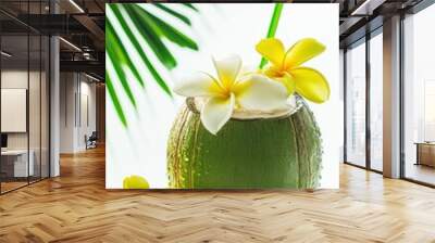 Tasty coconut drink with straw with coconut tree leaf in hot tropical summer Wall mural