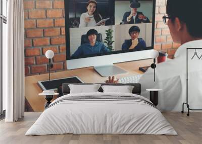 Asian man working from home use Smart working and video conference online meeting with Asian team using laptop and tablet online in video call for new projects Wall mural