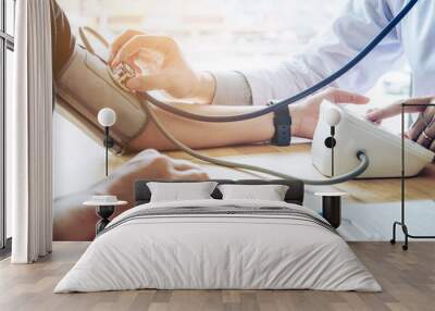 Doctor Measuring arterial blood pressure woman patient on arm Health care in hospital Wall mural