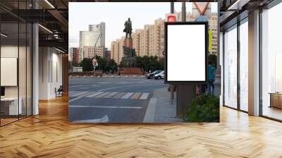 White blank vertical billboard in the city. Evening city, pedestrian crossing. Mock-up. Wall mural