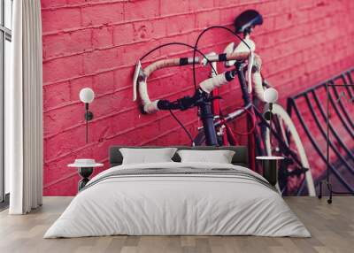 two vintage bicycle parking against colorful wall in city Wall mural