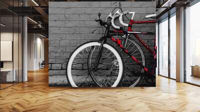 two vintage bicycles parking against red brick wall Wall mural