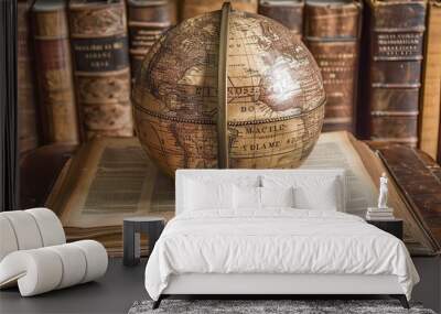 Antique globe resting on open book symbolizing scientific exploration Wall mural