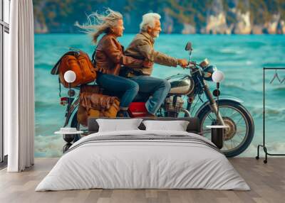 Elderly couple riding a motorbike on the sand beach Wall mural