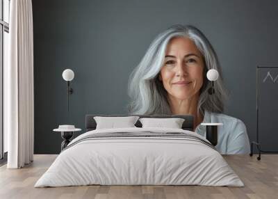 A woman with gray hair wearing a white shirt. Wall mural