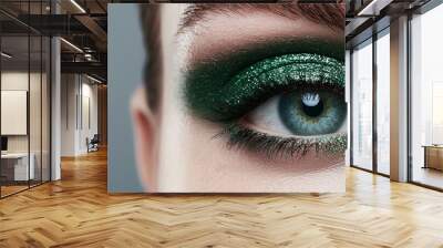 Close-up of a bold eye makeup look featuring metallic green eyeshadow with a smoky blend, highlighting intense beauty and artistic makeup styles Wall mural