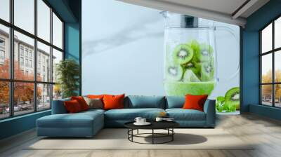 Modern kitchen blender with kiwi and green fruits, fresh ingredients ready for a smoothie, vibrant and healthy lifestyle concept Wall mural