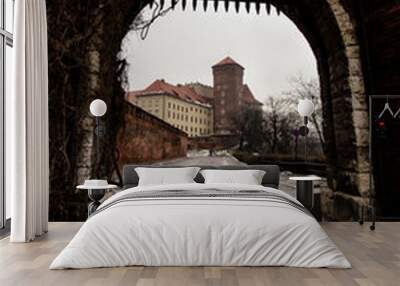 ancient barbican, silhouetted by external light, Wawel castle in the background, Wall mural