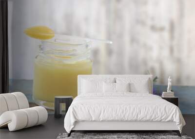 organic royal jelly in a glass bottle and full spoon on , with lavender decoration Wall mural