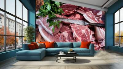 Many pieces of fresh pork meat on a wooden cutting board Wall mural