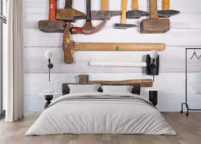 set of different types of old hammers on a wooden background. top view. Wall mural