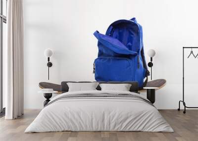 Blue open backpack sitting on skateboard, back to school concept Wall mural