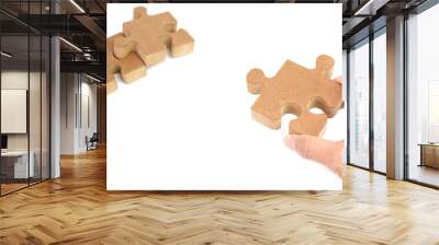 Wooden puzzle, jigsaw lie on white background. Wall mural