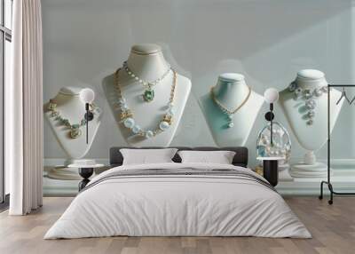 A collection of elegant necklaces displayed on white mannequins in a jewelry store showcase. Wall mural