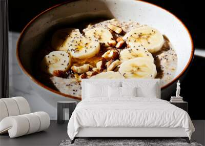 A bowl of oatmeal with bananas and nuts Wall mural