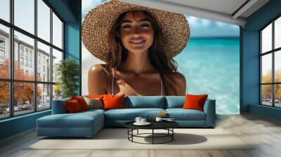 A woman wearing a straw hat and a bikini is smiling at the camera Wall mural